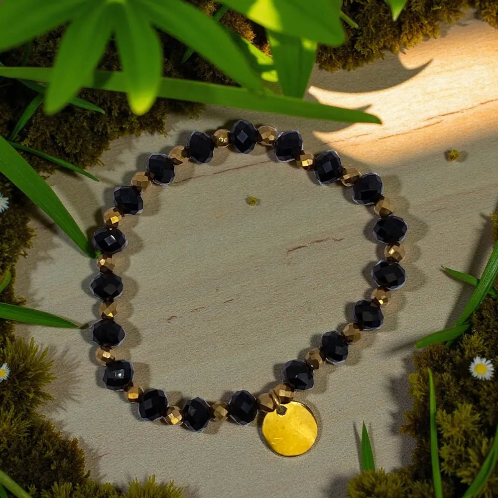 Bransoletka czarno złota z okrągłą zawieszką Lunnea